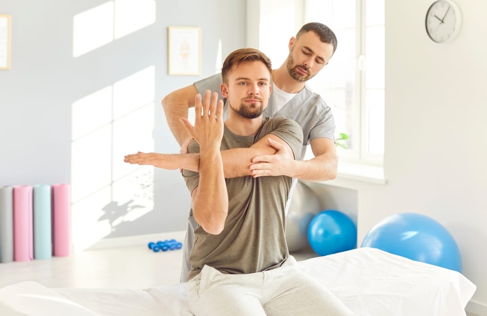 A chiropractor assists with guided shoulder mobility and range-of-motion therapy to reduce stiffness, improve function, and support recovery – Waynesville Chiropractor